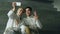 Two young smiling fencers man and woman taking self portrait on smartphone camera after fencing training indoors