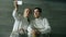 Two young smiling fencers man and woman taking selfie on smartphone camera after fencing training indoors