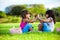 Two young smiling girls sitting in the grass