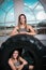 Two young smiling happy fitness women resting on a tyre