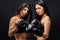 two young sportive brunette women engaged in boxing