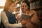 Two young students girl in library reading book.