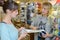 Two young tailors measure material