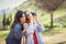 Two young tourist women taking photographs outdoors