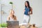 Two young woman colleague at office working standing and talking