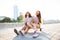 Two Young Woman sitting on Skateboard Happy Smiling. Playful Friends Enjoy Sunny day. Outdoor Urban. Beautiful Model