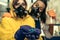 Two young women chemists working at scientific laboratory with drugs