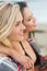 Two young women covered with blanket at beach