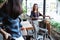 Two young women cyclists meeting at the cafe