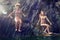 Two young women diving from a cliff in the sea