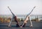 Two young women doing partner yoga asana downward facing dog