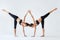 Two young women doing yoga asana Ardha Chandrasana