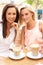 Two Young Women Enjoying Cup Of Coffee