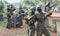 Two young women friends in camouflage holding guns ready for playing paintball