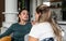 Two young women friends, roommates, business partners and owners of a small business are arguing at home due to the inappropriate
