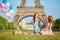 Two young women having picnic near the Eiffel tower in Paris, France