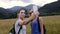 Two young women hiking take selfie portrait at mountain