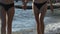 Two Young Women Holding Hands Walking on Beach