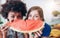 Two young women holding slice of watermelon