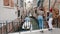 Two young women are look afar leaning on the bridge On the streets of Venice.