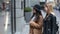 Two young women looking at clothing store window