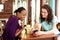 Two young women looking at mobile phone at cafe