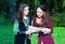 Two young women in medieval dresses reading papers