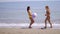 Two young women playing with a beach ball