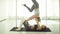 Two young women practicing acrobatic yoga.
