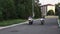 Two young women are riding motorcycles at early evening without helmets