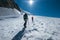 Two young women Rope team ascending Mont Blanc Monte Bianco summit 4,808m dressed mountaineering clothes with ice axes walking