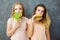 Two young women with salad and hamburger