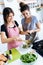 Two young women serving a vegetable stir-fry on the plate.