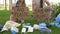 Two young women squatting near a pile of garbage with posters SAVE THE PLANET and NO PLASTIC. Tons of garbage was added