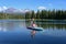 Two young women on standup paddle board on Scott Lake, Oregon.