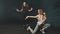 Two young women training their dancing in the dark studio