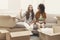 Two young women unpacking moving boxes