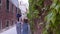 Two young women walking in panamas on the Italy streets at summer weather