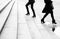 Two young women walking up and down the huge city stairs moving