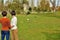 Two young women watching a dog play with crows.