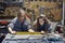 two young women working in a mechanic shop