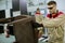 Two young workers assembling furniture in the factory