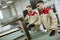 Two young workers assembling furniture in the factory