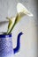 Two Zantedeschia aethiopica in a recycled vase. minimalist studio photo. selective focus. copy space. wedding bouquet. water lily