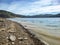 Tygart Lake in Tygart Lake State Park in West Virginia, in the spring with the shoreline filled with sand and rocks leading to the