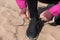 Tying shoelaces on sneakers. Girl prepares for sports running