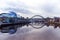 Tyne Bridge mirrored in the River Tyne, Newcastle, UK along with Gateshead Sage building and the Quayside