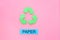 Types of matherial for reycle and reuse. Printed word paper near eco symbol recycle arrows on pink background top view