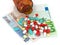 Types of pills lying on euro banknotes and bottle of pills on