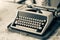 Typewriter. An old typewriter on a working desk in vintage sepia